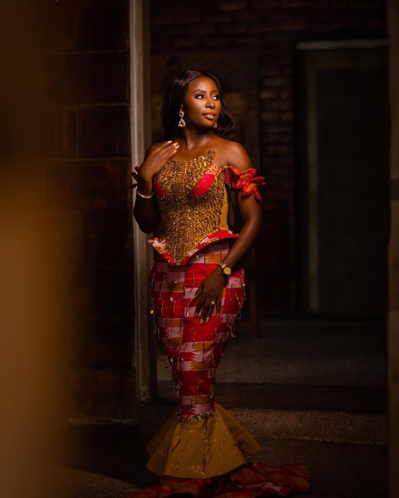 A bride in her two piece engagement red kente