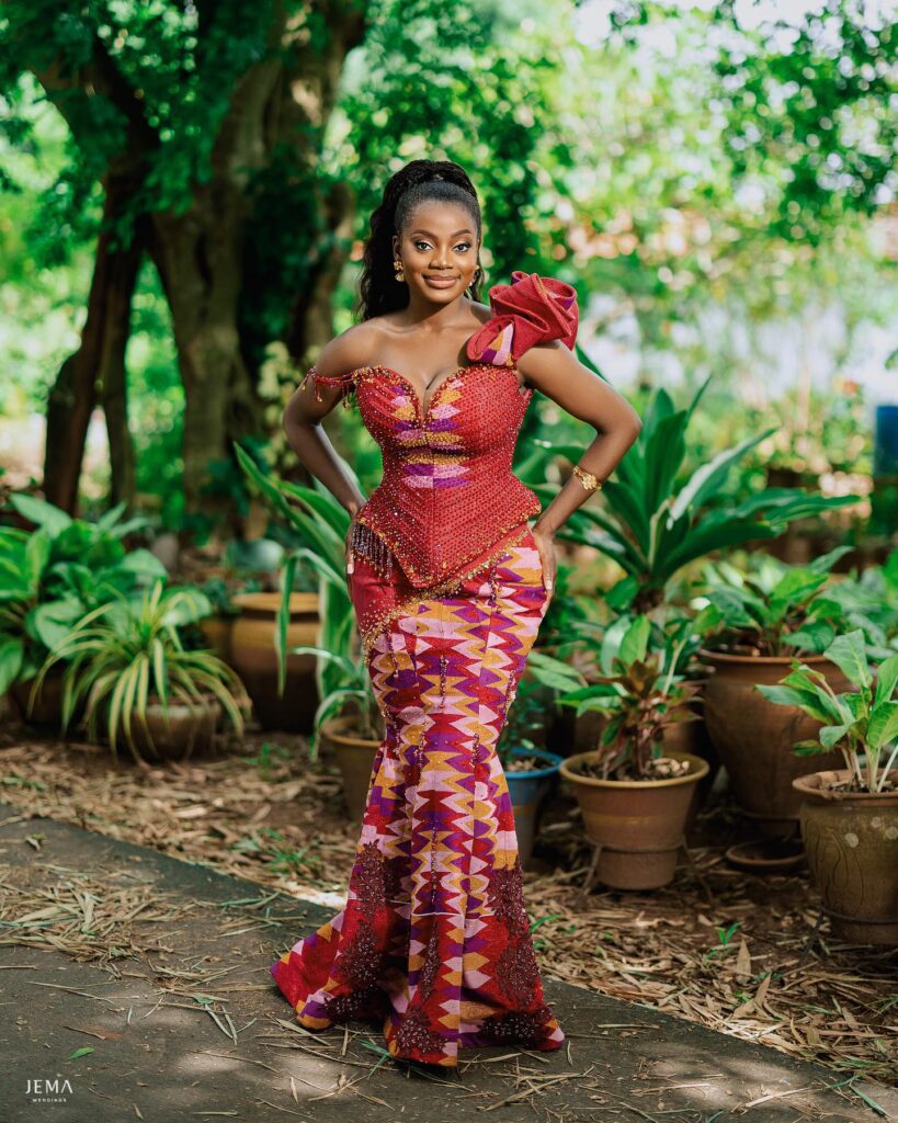 A bride in her two piece engagement kente without greenery in the backgrond