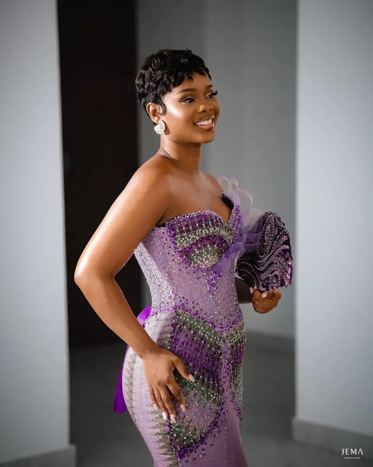 A bride in her off shoulders engagement kente dress