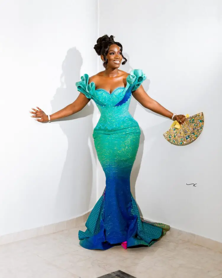 A beautiful Ghanaian bride wearing an ombre kente engagement dress