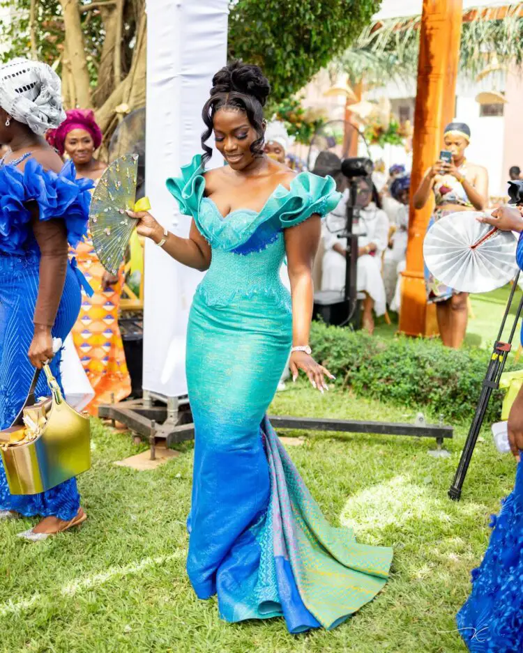 A beautiful Ghanaian bride wearing an ombre kente engagement dress