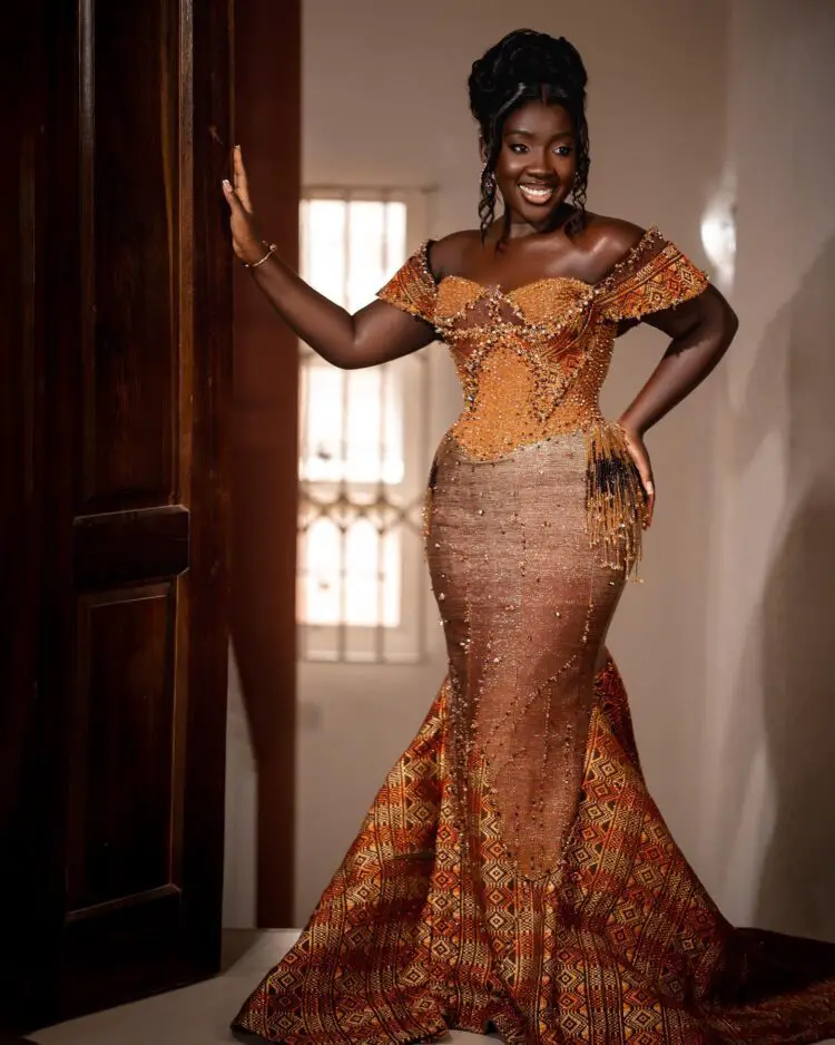 A beautiful Ghanaian bride wearing an ombre kente engagement dress