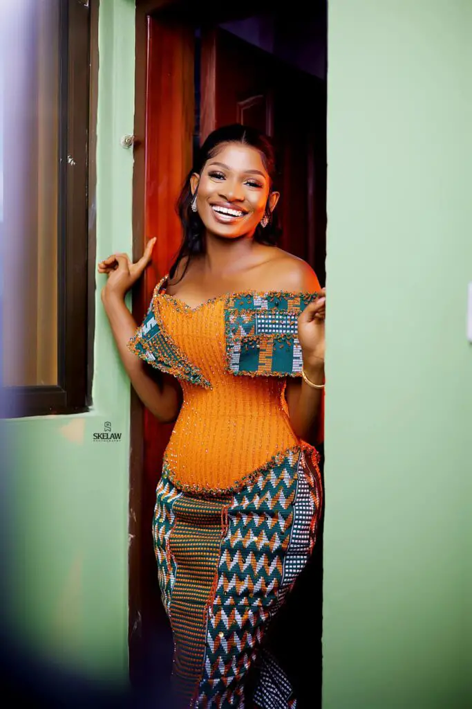 Ghanaian in a green kente styled dress