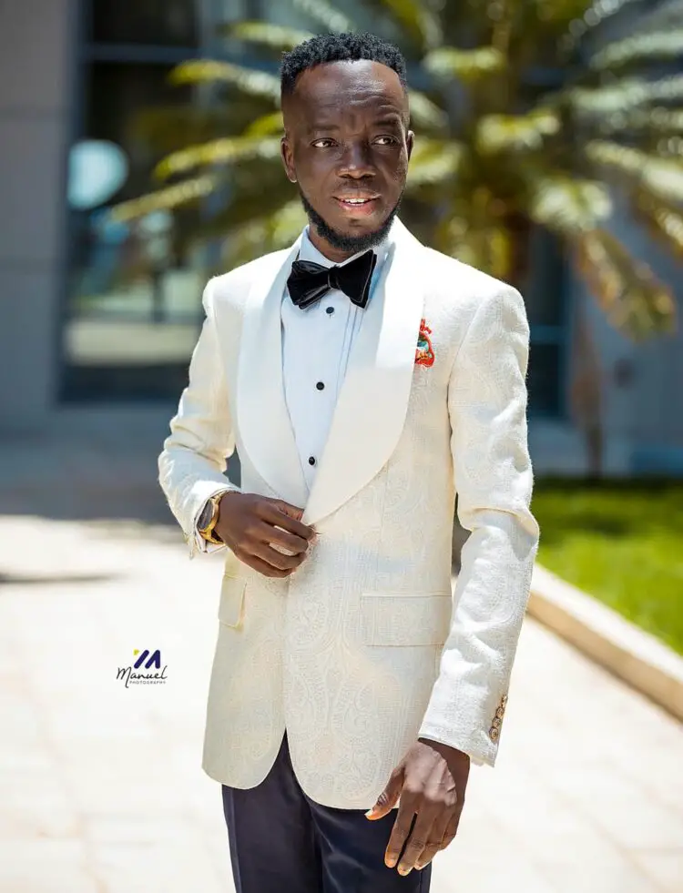 Akwaboah's in a tuxedo for his White Wedding Ceremony