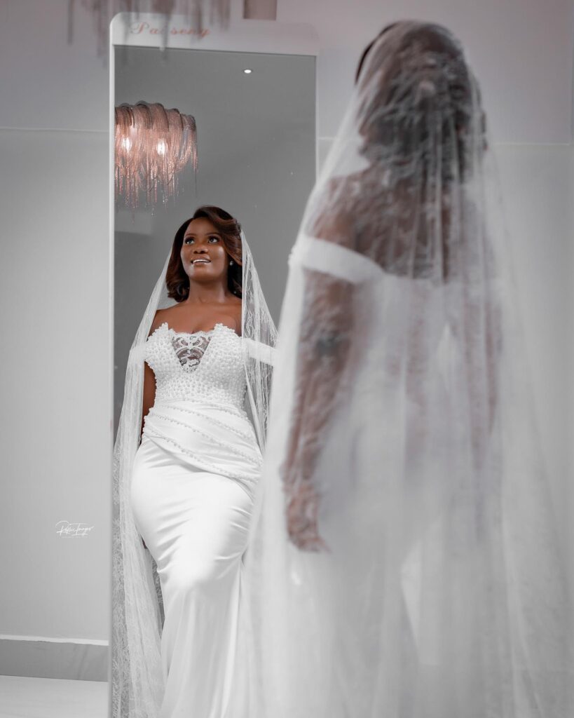 The back of A Ghanaian bride in a long Civil Wedding Dress with veil