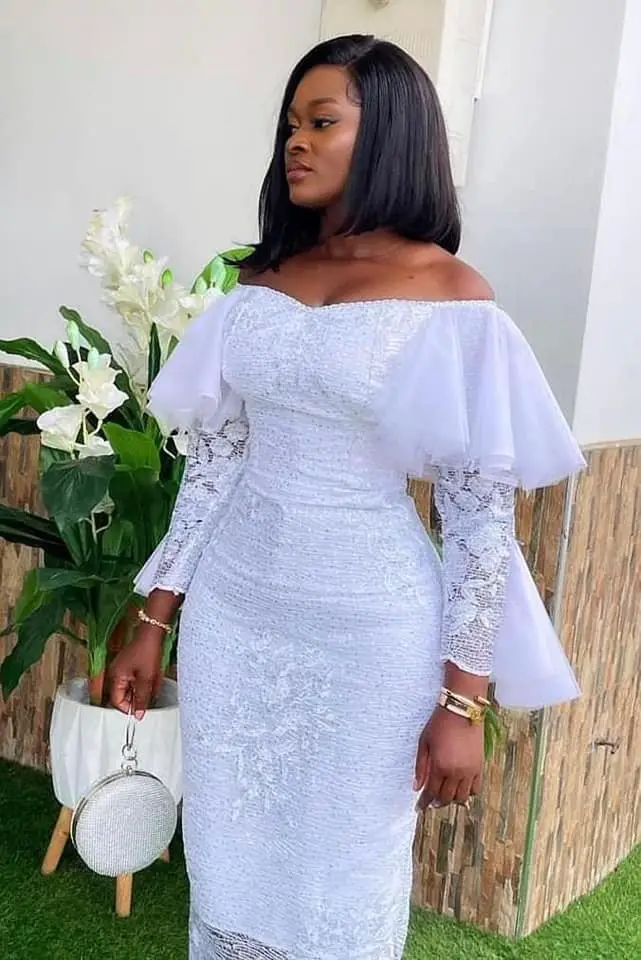 Lad in wedding guest white lace dress styles in Ghana 