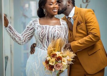 Perez Musik and his wife pose for pictures