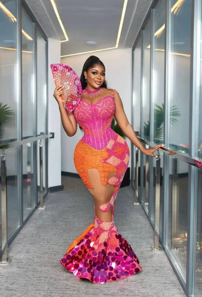 BRIDE IN PINK AND ORANGE KENTE